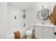 Bright bathroom features modern vanity, tiled tub and shower, with modern decor at 3070 N Glencoe St, Denver, CO 80207
