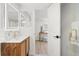 Stylish bathroom features modern vanity, tiled shower, and adjacent bedroom at 3070 N Glencoe St, Denver, CO 80207