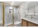 Bright bathroom features luxurious gold shower and vanity with stylish backsplash at 3070 N Glencoe St, Denver, CO 80207