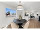 Cozy dining area with a modern light fixture and a large window overlooking the outdoors at 3070 N Glencoe St, Denver, CO 80207