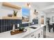 Close up of a kitchen featuring open shelving, modern backsplash, and stainless steel fixtures at 3070 N Glencoe St, Denver, CO 80207