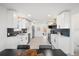 Spacious kitchen with white cabinetry, stainless steel appliances, and modern backsplash at 3070 N Glencoe St, Denver, CO 80207
