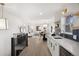 Open living space with updated kitchen, dining area, and living room on hardwood floors at 3070 N Glencoe St, Denver, CO 80207