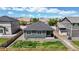 Aerial view of backyard with lawn, wooden fence, patio, and low maintenance landscaping at 4642 Longs Peak St, Brighton, CO 80601