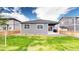 Charming backyard with green lawn, wooden fence, patio, and low maintenance landscaping at 4642 Longs Peak St, Brighton, CO 80601