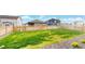 Expansive backyard with a lush green lawn, new wooden fence, and professional landscaping at 4642 Longs Peak St, Brighton, CO 80601