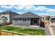 Home features a backyard with a lawn, wooden fence, patio, and low maintenance landscaping at 4642 Longs Peak St, Brighton, CO 80601