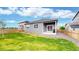 Well-maintained backyard features a green lawn, wooden fence, patio, and low maintenance landscaping at 4642 Longs Peak St, Brighton, CO 80601