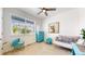 Bright bedroom with a large window, a colorful dresser, and charming decor creating a cozy and inviting space at 4642 Longs Peak St, Brighton, CO 80601