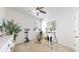 Bedroom designed as a home gym featuring carpet, exercise equipment, ceiling fan, and a leafy green plant at 4642 Longs Peak St, Brighton, CO 80601