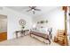 Comfortable bedroom with a daybed, carpet flooring, a rocking chair, and a ceiling fan at 4642 Longs Peak St, Brighton, CO 80601