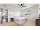Comfortable bedroom featuring a cozy bed, side tables with lamps, and a view into another room at 4642 Longs Peak St, Brighton, CO 80601