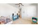 Bright bedroom with a blue console table, a metal framed day bed, and decorated with kid-friendly items at 4642 Longs Peak St, Brighton, CO 80601