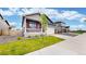 Attractive home boasting a manicured lawn, a two-car garage, and a cozy front porch with delightful curb appeal at 4642 Longs Peak St, Brighton, CO 80601