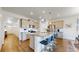 Contemporary kitchen with stainless steel appliances, a center island with bar seating, and elegant pendant lighting at 4642 Longs Peak St, Brighton, CO 80601