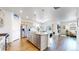 Well-lit kitchen featuring stainless steel appliances, a central island with seating, and an open layout to the living area at 4642 Longs Peak St, Brighton, CO 80601