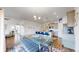 Open-concept kitchen and dining area featuring modern appliances, a breakfast bar, and an abundance of natural light at 4642 Longs Peak St, Brighton, CO 80601
