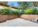 Secluded backyard patio area surrounded by lush trees and shrubbery at 1076 Rosemary St, Denver, CO 80230