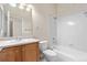 Clean bathroom with neutral tones features a single sink vanity and shower over tub at 1076 Rosemary St, Denver, CO 80230