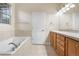 Bright bathroom with bath tub, enclosed shower and modern fixtures at 1076 Rosemary St, Denver, CO 80230