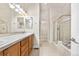 Bright bathroom boasts double sinks, bathtub and glass enclosed shower at 1076 Rosemary St, Denver, CO 80230