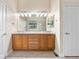 Bathroom featuring a double sink vanity with a large mirror and ample cabinet space at 1076 Rosemary St, Denver, CO 80230