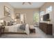 Comfortable bedroom featuring neutral decor, a large bed, and a dresser with television at 1076 Rosemary St, Denver, CO 80230