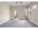 Spacious bedroom with neutral carpet, ceiling fan, a view of the back yard and bathroom access at 1076 Rosemary St, Denver, CO 80230