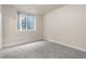 Neutral bedroom offering a cozy space with soft gray carpeting and window at 1076 Rosemary St, Denver, CO 80230