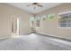 Bedroom with carpet, ceiling fan, bathroom access, and a view of the backyard at 1076 Rosemary St, Denver, CO 80230