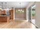 Well-lit dining room with hardwood floors and a chandelier for cozy gatherings at 1076 Rosemary St, Denver, CO 80230