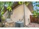 Exterior of house showing steps to entry, air conditioning unit and gated area at 1076 Rosemary St, Denver, CO 80230