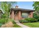 Charming single-story home with brick accents, manicured landscaping, and a welcoming front porch at 1076 Rosemary St, Denver, CO 80230