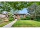 Charming single-story home featuring a well-manicured lawn and inviting, covered front porch at 1076 Rosemary St, Denver, CO 80230