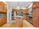 Well-lit kitchen featuring wood cabinets, granite countertops, stainless steel appliances and a kitchen island at 1076 Rosemary St, Denver, CO 80230