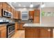 Kitchen featuring stainless steel appliances, granite countertops, wooden cabinets, and hardwood floors at 1076 Rosemary St, Denver, CO 80230