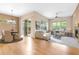 Bright living room and dining area with hardwood floors, fireplace, and sliding glass door to the patio at 1076 Rosemary St, Denver, CO 80230