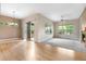 Open layout joining living area with patio access, featuring hardwood floors and plush carpet at 1076 Rosemary St, Denver, CO 80230
