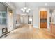 Open-concept living and kitchen space with hardwood floors and access to the outdoor patio at 1076 Rosemary St, Denver, CO 80230