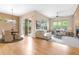 Bright living room featuring hardwood floors, a fireplace, large windows and access to an outdoor patio at 1076 Rosemary St, Denver, CO 80230