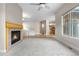 Cozy living room with a fireplace, plush carpeting, and large windows with natural light at 1076 Rosemary St, Denver, CO 80230