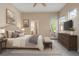 Bright main bedroom with a door to the backyard, ensuite bathroom, and neutral decor at 1076 Rosemary St, Denver, CO 80230
