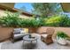 Cozy outdoor patio featuring stylish furniture, a patterned rug, and lush green landscaping at 1076 Rosemary St, Denver, CO 80230