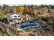 Aerial view of the estate highlighting a large pool, spa, outdoor seating, lush landscaping, and modern farmhouse style at 6709 Walker Ct, Niwot, CO 80503