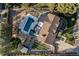 Aerial view of a property featuring a pool, spa, lounge area, gardens, shed, and a well-maintained lawn at 6709 Walker Ct, Niwot, CO 80503