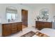 This bathroom boasts dual wood vanities with marble countertops, mirrors, and a walk-in closet at 6709 Walker Ct, Niwot, CO 80503