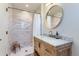 This bright bathroom features a vanity with stone countertop and a tiled shower area at 6709 Walker Ct, Niwot, CO 80503