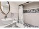 This stylish bathroom features a modern sink, vanity, and shower with decorative tile at 6709 Walker Ct, Niwot, CO 80503