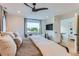 This primary bedroom features a ceiling fan, sitting area, and a large window with scenic views at 6709 Walker Ct, Niwot, CO 80503
