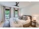 This bedroom features many windows with natural light, a ceiling fan, and hardwood floors at 6709 Walker Ct, Niwot, CO 80503